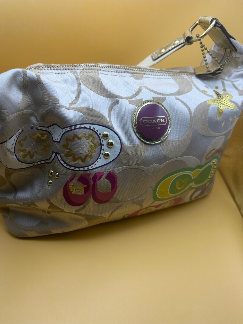 Coach beige purse with Multicolor Graphics beautiful